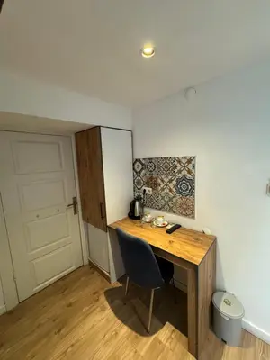 a room with a wooden desk with a chair and a door at Veva Homes in Istanbul