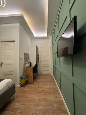 a room with a bed and a television on a wall at Veva Homes in Istanbul