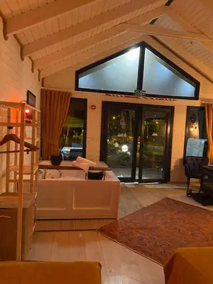 a living room with a tub and a large window at BungalovCity in Sapanca