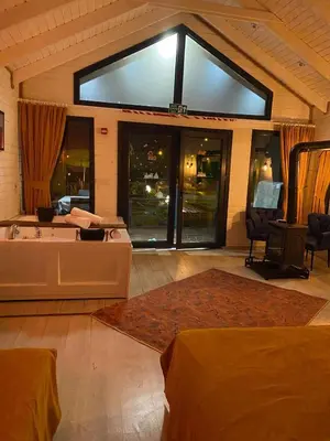 a living room with a large window and a couch at BungalovCity in Sapanca