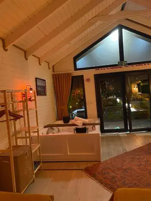 a room with a bath tub and windows at BungalovCity in Sapanca