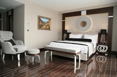 a hotel room with a bed and a chair at Ramada Hotel & Suites Sisli in Istanbul