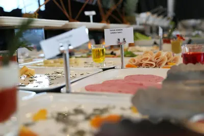 a table topped with plates of food and drinks at Ramada Hotel & Suites Sisli in Istanbul
