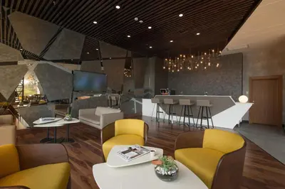 a restaurant with yellow chairs and a bar with a counter at Liv City Hotels in Istanbul