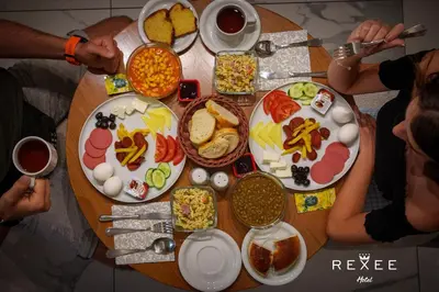 a wooden table with plates of food on it at Taksim REXXEE Istanbul Istiklal Hotel in Istanbul