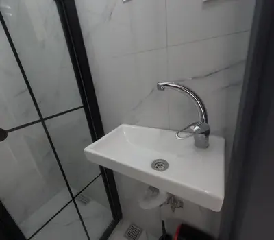 a bathroom with a white sink and a shower at lastbest hotel in Istanbul