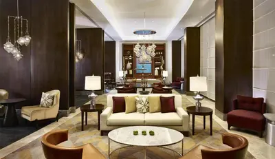 a living room with a couch and tables and chairs at Hyatt Regency Istanbul Atakoy in Istanbul