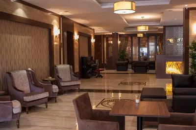 a lobby with chairs and tables in a hotel at Gorukle Oruc Hotel in Bursa