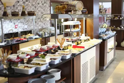 a buffet line with plates of food on display at Gorukle Oruc Hotel in Bursa