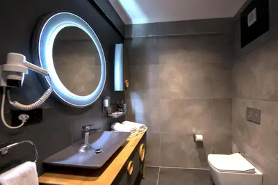 a bathroom with a sink and a mirror at Shiboo Suite Otel in Gebze
