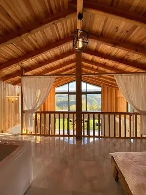 a large room with wooden ceilings and a large window at Eviniz rahatlığında, eşsiz doğa manzaralı dağ evi in Gölcük