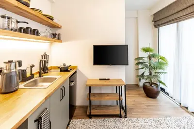 a kitchen with a sink and a tv on the wall at Mariposa Rooms Taksim in Istanbul