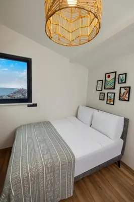 a bedroom with a white bed and a window at Mariposa Rooms Taksim in Istanbul