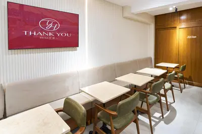 a dining room with tables and chairs and a red thank you sign at Thank You Hotel Sultanahmet in Istanbul