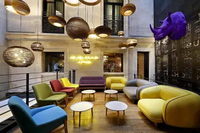 a lobby with colorful chairs and tables and lights at Hotel The Public - Special Category in Istanbul