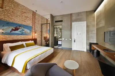 a bedroom with a bed and a brick wall at Hotel The Public - Special Category in Istanbul