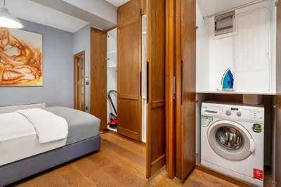 a bedroom with a bed and a washing machine at Urban Quarters - Asmalı Mescit in Istanbul