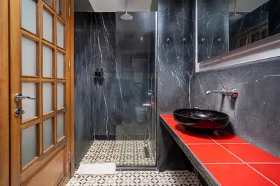 a bathroom with a bowl sink on a red counter at Urban Quarters - Asmalı Mescit in Istanbul