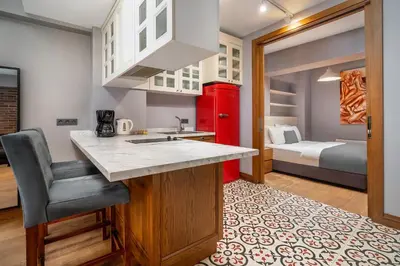 a kitchen with a sink and a red refrigerator at Urban Quarters - Asmalı Mescit in Istanbul