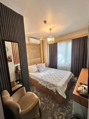a hotel room with a bed and two chairs at Taksim Cetinkaya Suite in Istanbul