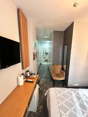 a hotel room with a bed and a chair at Taksim Cetinkaya Suite in Istanbul