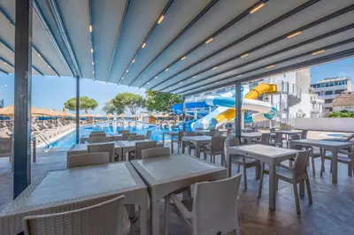 a restaurant with a pool and a water slide at Avsa Artemis Hotel in Avsa Adasi