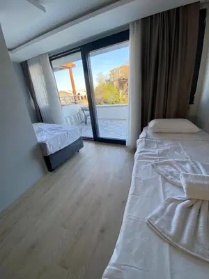 a bedroom with two beds and a large window at dolphin hotel cafe in Istanbul