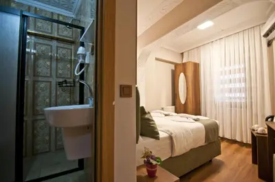 a bathroom with a bed and a sink in a room at Aurora Eco Hotel in Istanbul