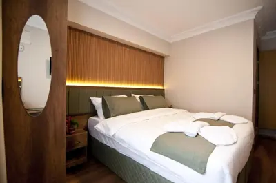 a bedroom with a large bed with towels on it at Aurora Eco Hotel in Istanbul