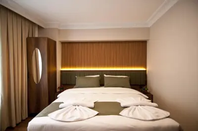 a bedroom with a large white bed with two pillows at Aurora Eco Hotel in Istanbul