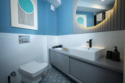 a bathroom with a sink and a toilet and a mirror at Bird Nest Suites in Istanbul