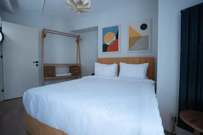 a bedroom with a large white bed and a window at Bird Nest Suites in Istanbul