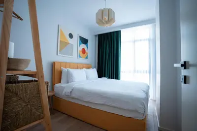 a bedroom with a bed and a large window at Bird Nest Suites in Istanbul