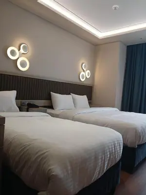 a hotel room with two beds and two mirrors at Theodosius Hotel in Istanbul