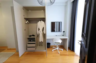 a closet with a desk and a chair in a room at İstanbul Guesthouse in Istanbul