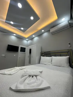 a bedroom with a bed with a white robe on it at IMMOR AKKUS HOTEL in Istanbul