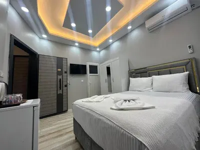 a bedroom with a bed with a towel on it at IMMOR AKKUS HOTEL in Istanbul
