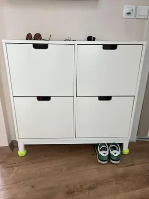 a white cabinet with two doors and two pairs of shoes at Cozy Place with Bosphorus View in Istanbul