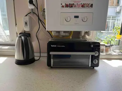 a toaster oven sitting on a counter next to a microwave at Cozy Place with Bosphorus View in Istanbul