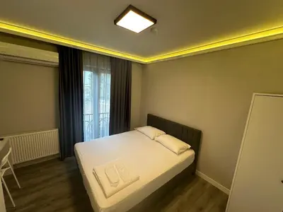 a small bedroom with a bed and a window at ASLAN AİRPORT Hotel in Arnavutköy