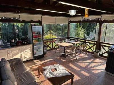 a screened in porch with a table and chairs at ASLAN AİRPORT Hotel in Arnavutköy