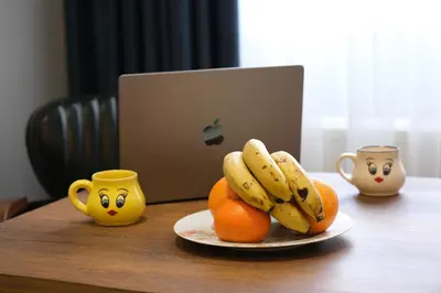 a plate of bananas and oranges on a table with mugs at Elita Otel Kumkapı in Istanbul