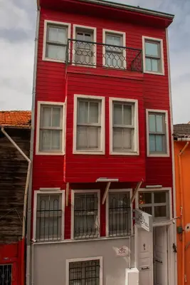 a red building with white windows and a balcony at NİA SULTANAHMET in Istanbul
