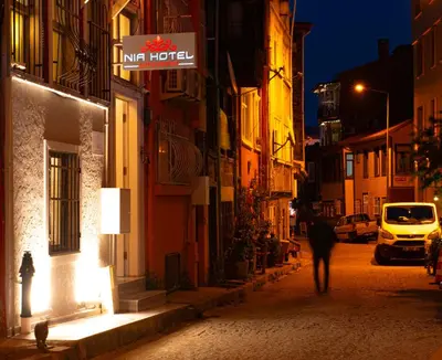 a person walking down a street at night at NİA SULTANAHMET in Istanbul