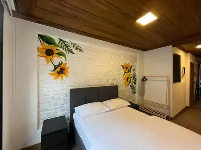 a bedroom with a white bed with flowers on the wall at Casa Mirasol Terrace Golden Horn Istanbul in Istanbul