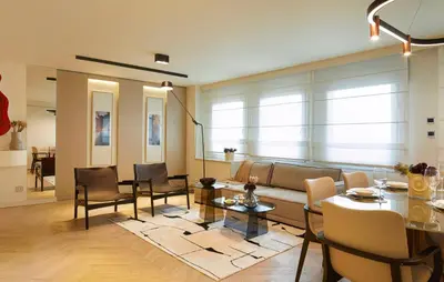a living room with a couch and a table and chairs at G Residences Gayrettepe in Istanbul
