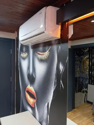 a kitchen with a painting of a woman with lashes at Bonita Boutique in Istanbul