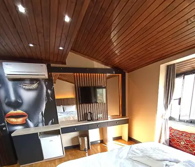 a bedroom with a picture of a face on the wall at Bonita Boutique in Istanbul
