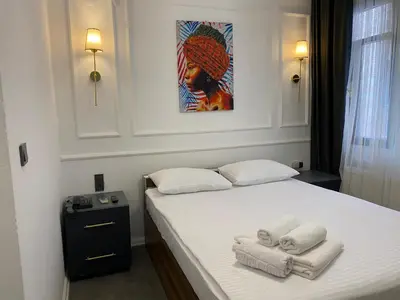 a bedroom with a bed with towels on it at Global Termal Hotel in Çekirge