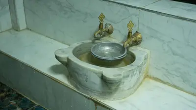 a metal sink with a bowl and two faucets at Global Termal Hotel in Çekirge